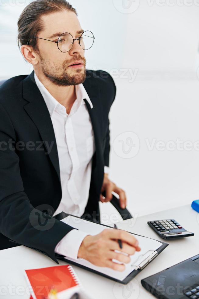 Mens in een pak documenten werk kantoor laptop technologieën foto