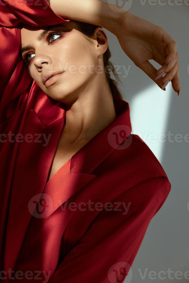 aantrekkelijk vrouw met helder bedenken looks naar de kant rood jasje detailopname foto