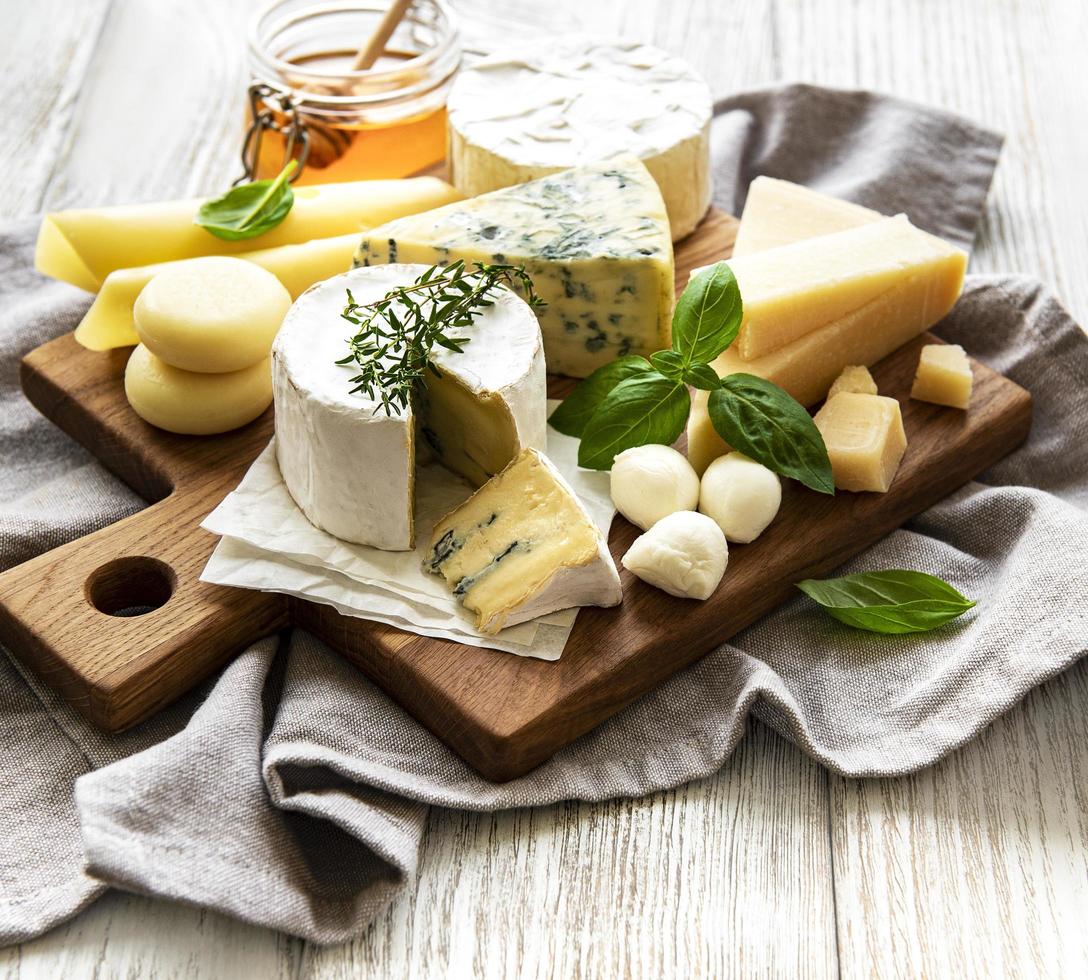 verschillende soorten kaas op een witte houten achtergrond foto