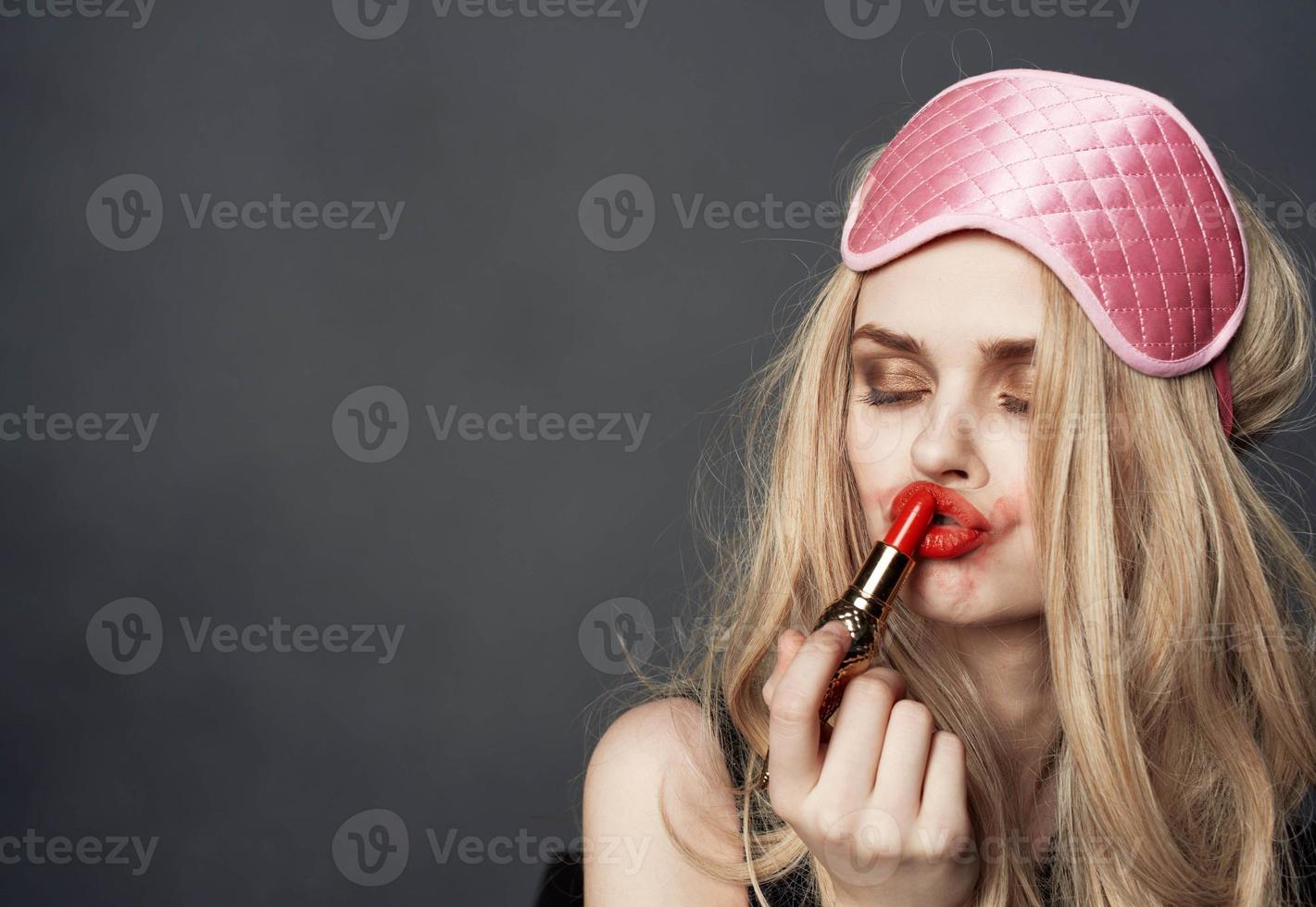 blond met lippenstift uitstrijkjes bedenken Aan haar gezicht en oog schaduw foto