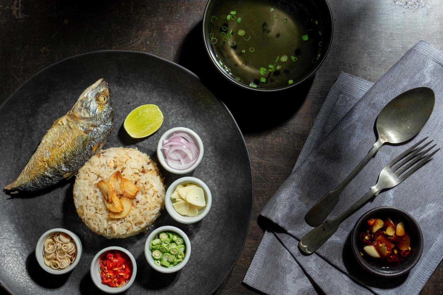 Bovenaanzicht gerecht van gebakken rijst geserveerd met verse ingrediënten en soep foto