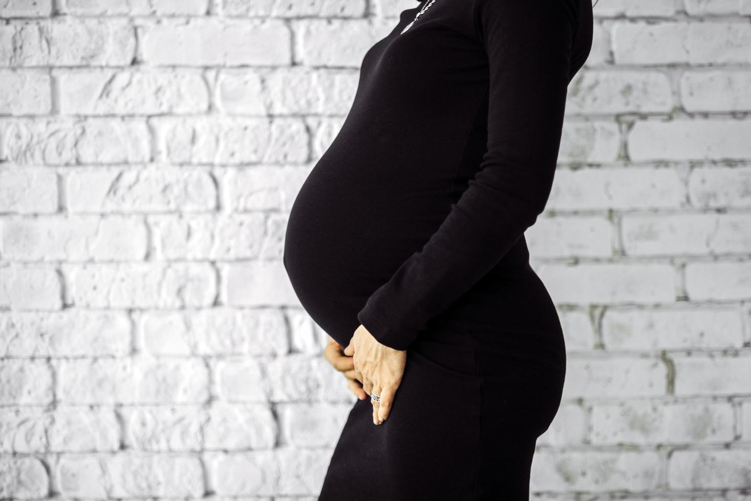 zwangere vrouw in zwarte jurk foto