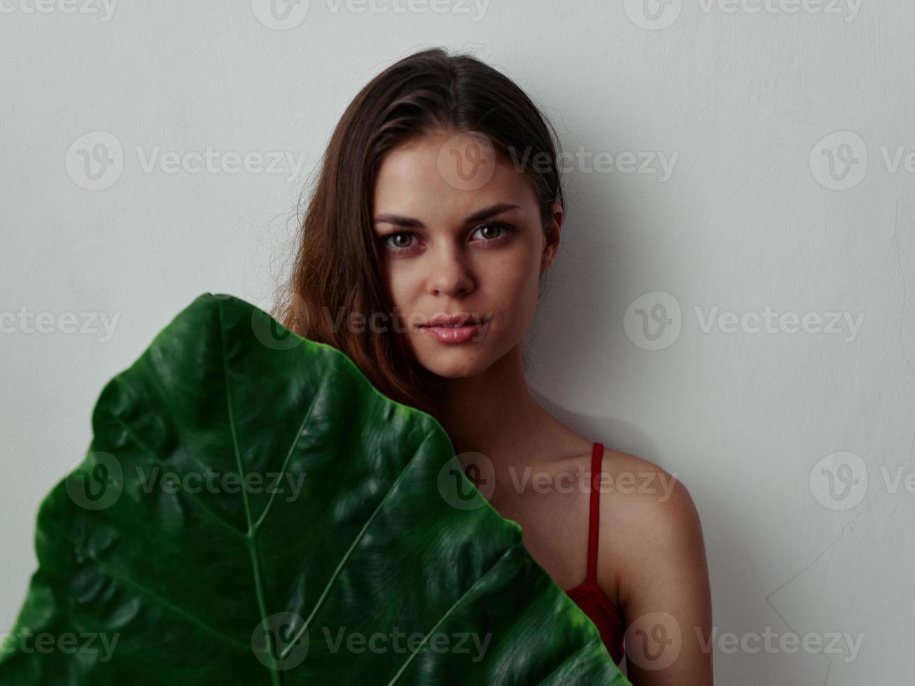 vrouw in rood zwempak palm blad exotisch aantrekkelijk kijken foto