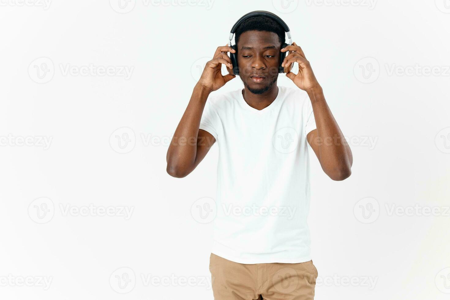 Mens van Afrikaanse uiterlijk in hoofdtelefoons muziek- technologie geïsoleerd achtergrond foto