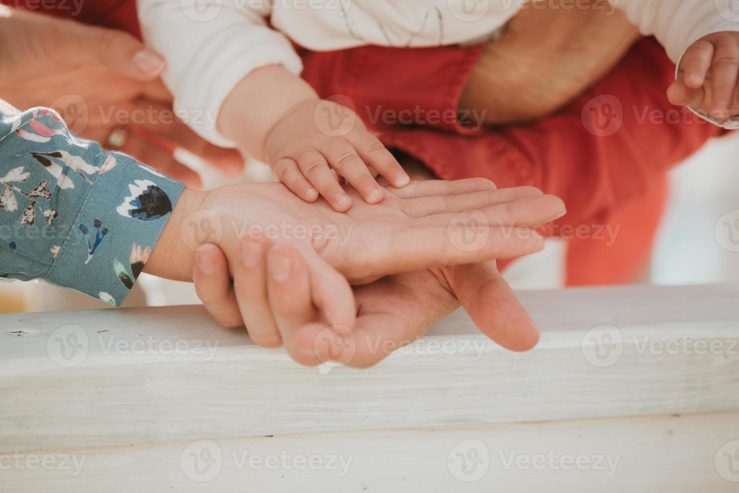 mama en papa houden de hand van de baby vast. handvat voor kinderen foto