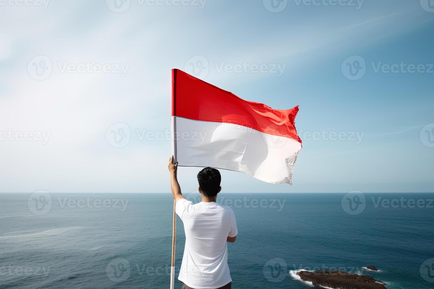 een Mens Holding een rood en wit Indonesië vlag op zoek Bij de oceaan. ai gegenereerd foto