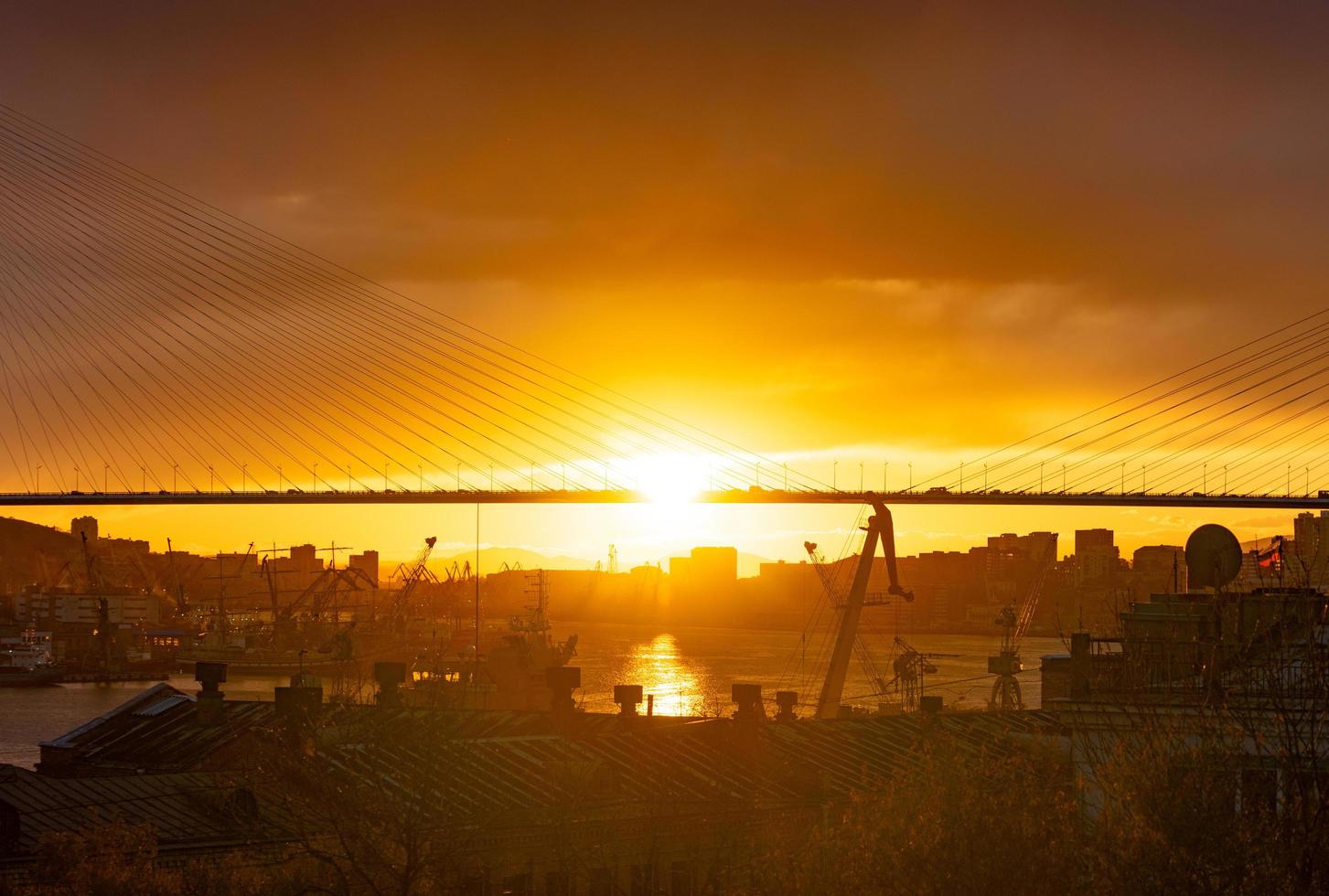 silhouetten van de skyline van een stad en de gouden brug in Vladivostok, Rusland foto