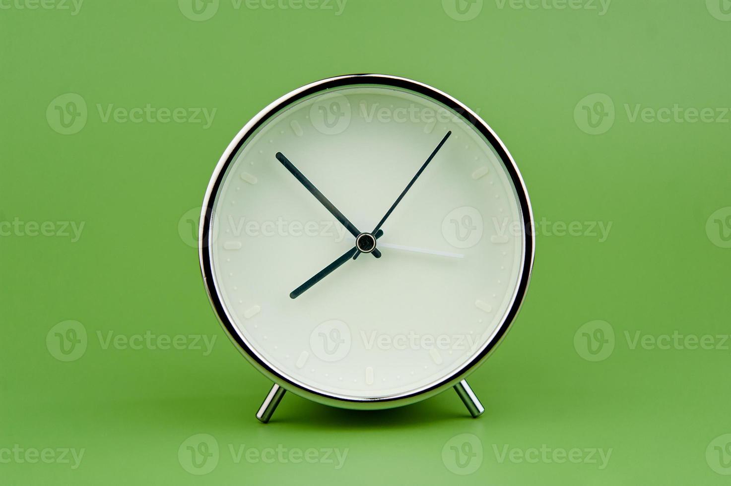 alarm klok Aan groen achtergrond tijd concept werken met tijd kostbaar tijd foto