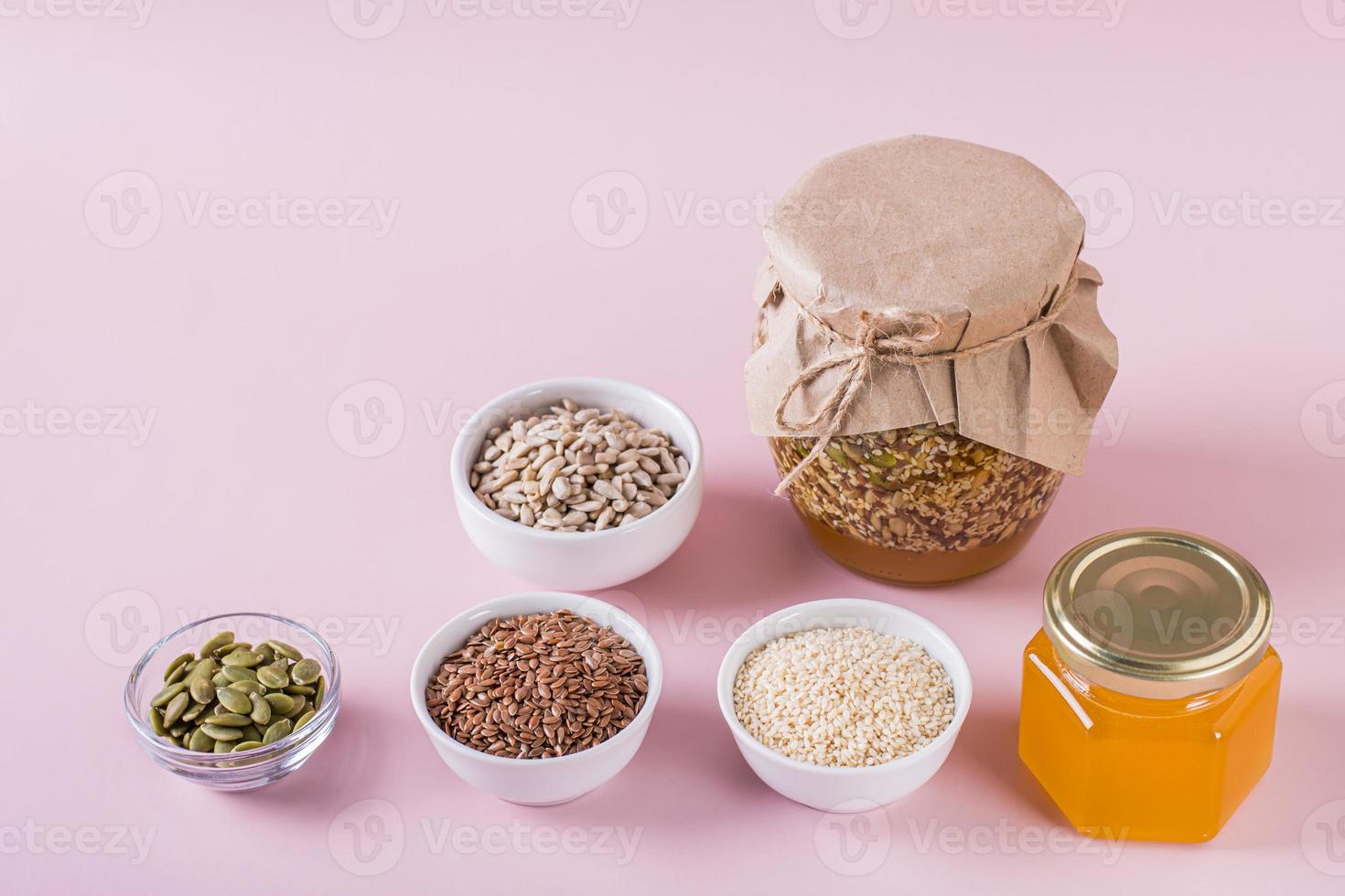 gezond mengsel van honing en divers zaden in een pot en ingrediënten voor Koken foto