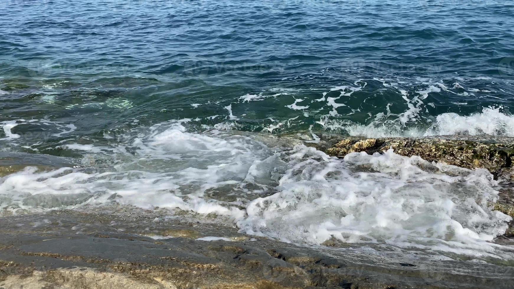 oceaangolven die op rots kabbelen foto