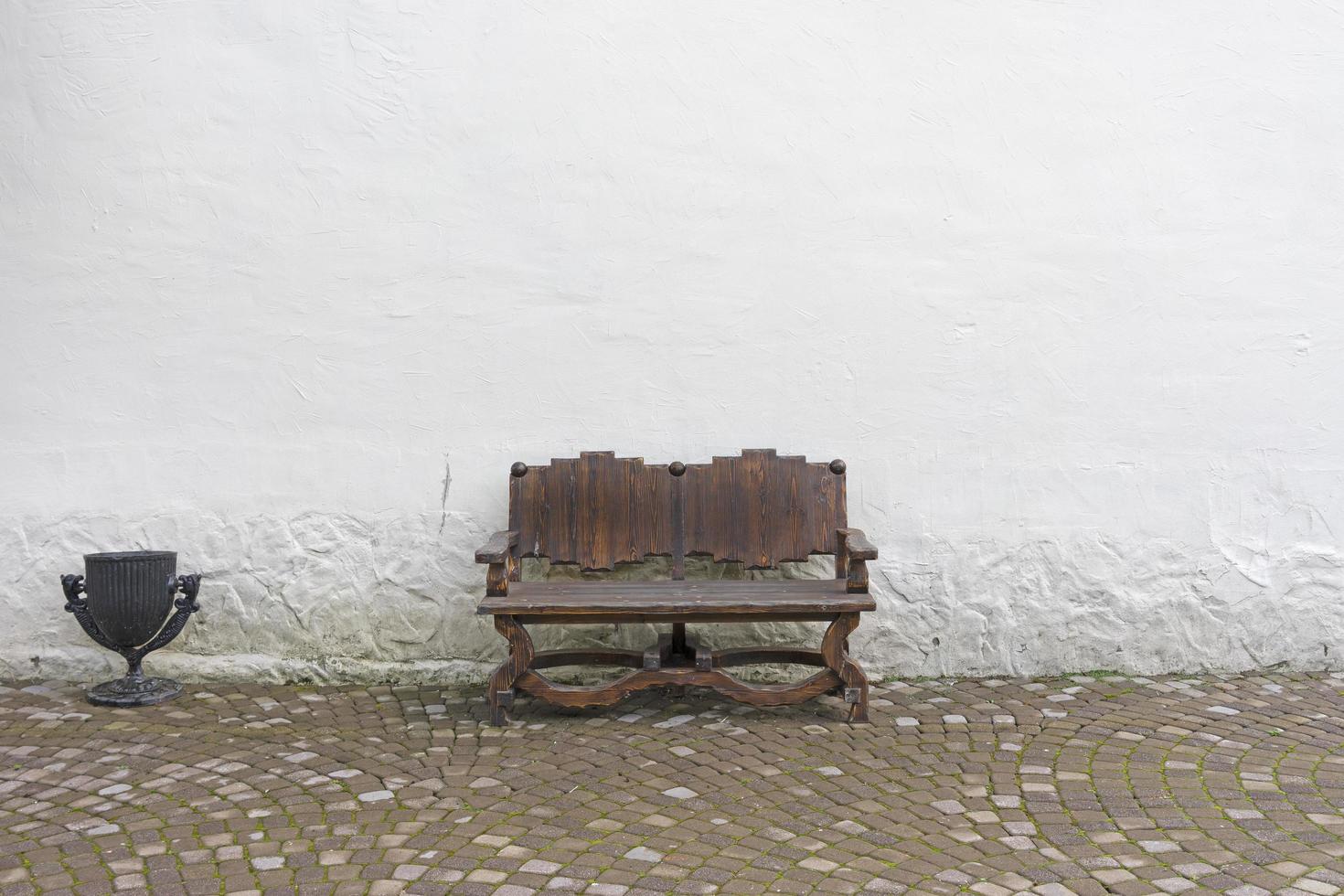 houten bankje op een witte muur achtergrond foto