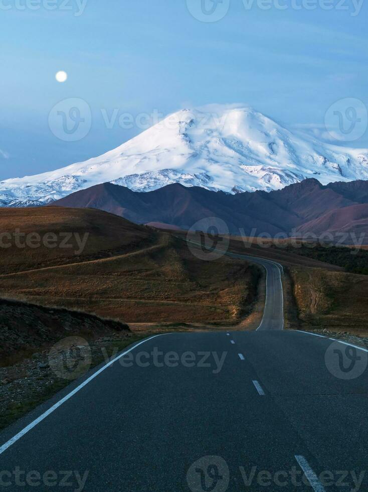 verticaal ochtend- landschap met kronkelend snelweg naar monteren elbrus foto