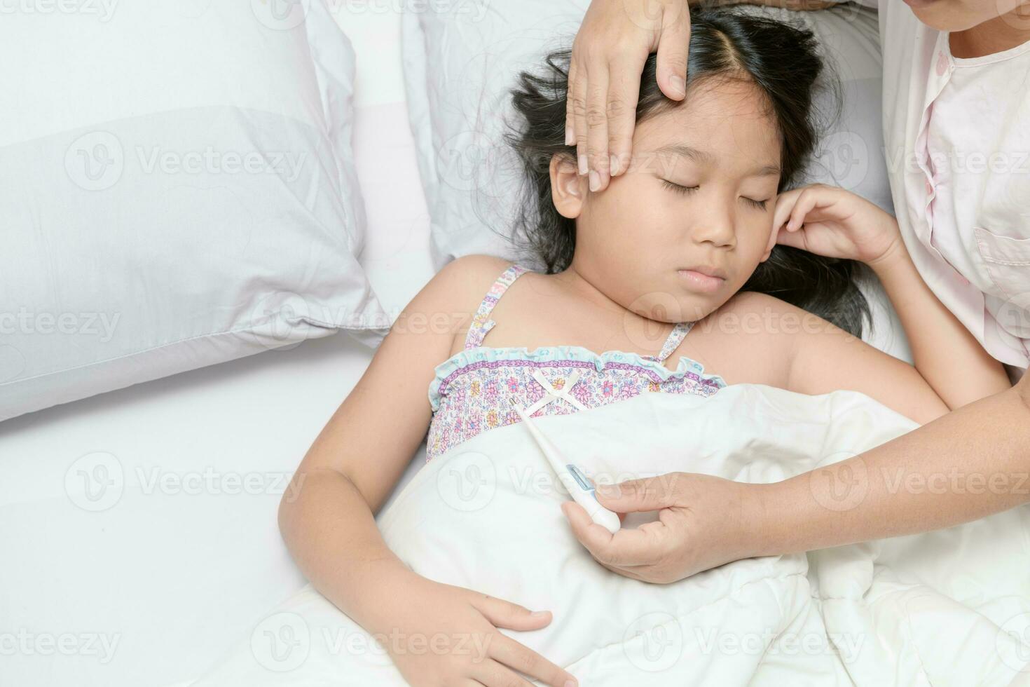ziek kind met hoog koorts houdende in bed foto