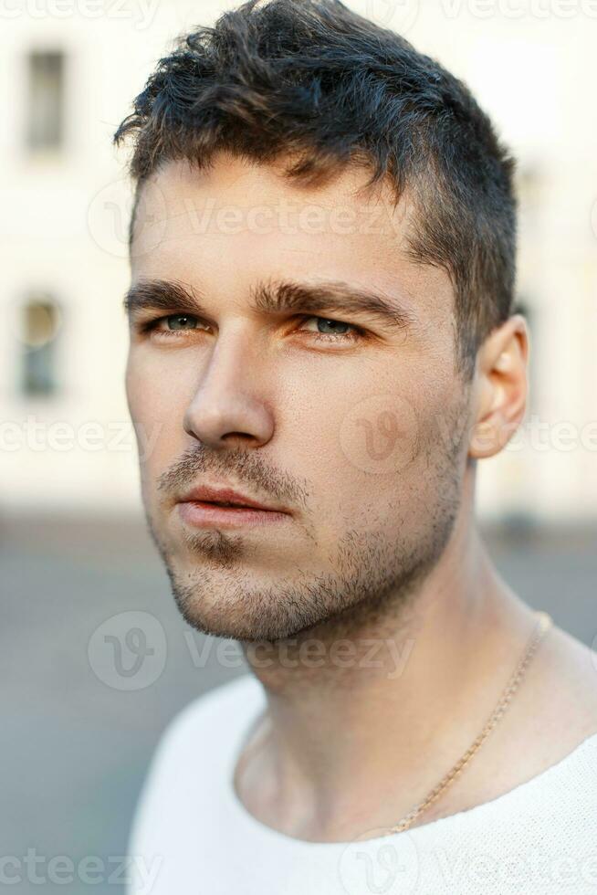 detailopname portret van een gewoontjes knap Mens met een baard op zoek Bij camera, buitenshuis foto