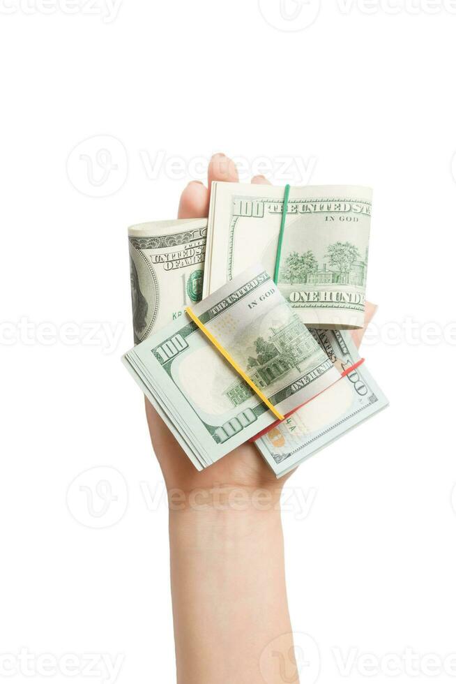 top visie van vrouw hand- Holding een veel van gerold omhoog dollar bankbiljetten Aan wit geïsoleerd achtergrond. armoede concept. credit concept met kopiëren ruimte foto