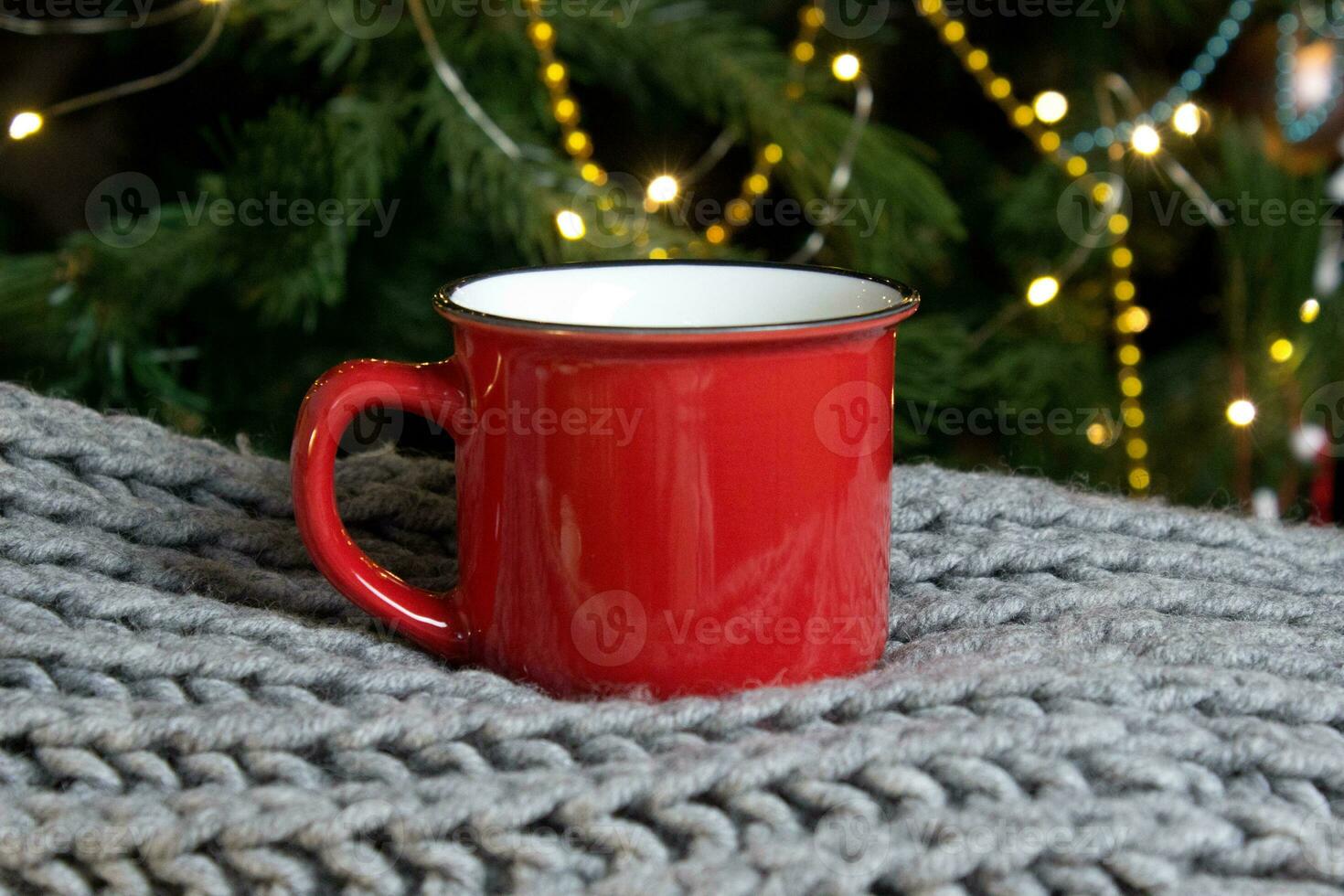 blanco rood mok met Kerstmis boom Aan achtergrond, mat thee of koffie kop met Kerstmis en nieuw jaar decoratie, verticaal bespotten omhoog met keramisch mok voor heet drankjes, leeg geschenk afdrukken sjabloon. foto