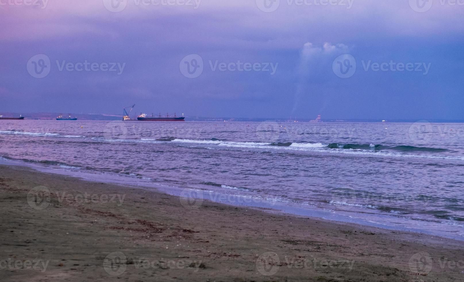 blauw uur op een stormachtige dag op het strand van mckenzie, larnaca, cyprus foto