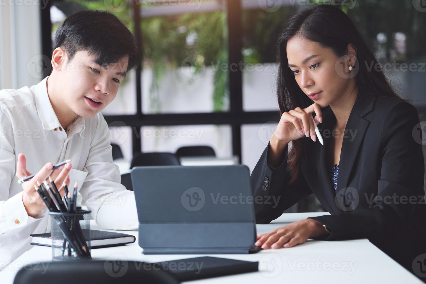 twee professionals in een vergadering met een tablet foto