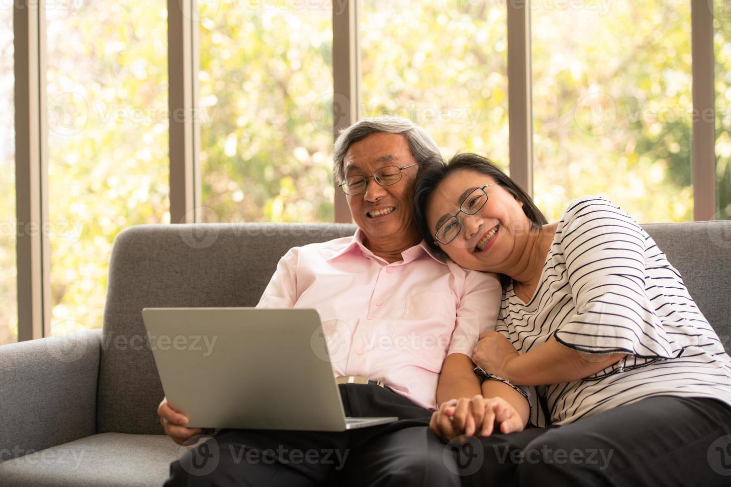 senior aziatische man en vrouw ontspannen op vakantie in de natuurlijke woonkamer achtergrond met moderne technologie foto