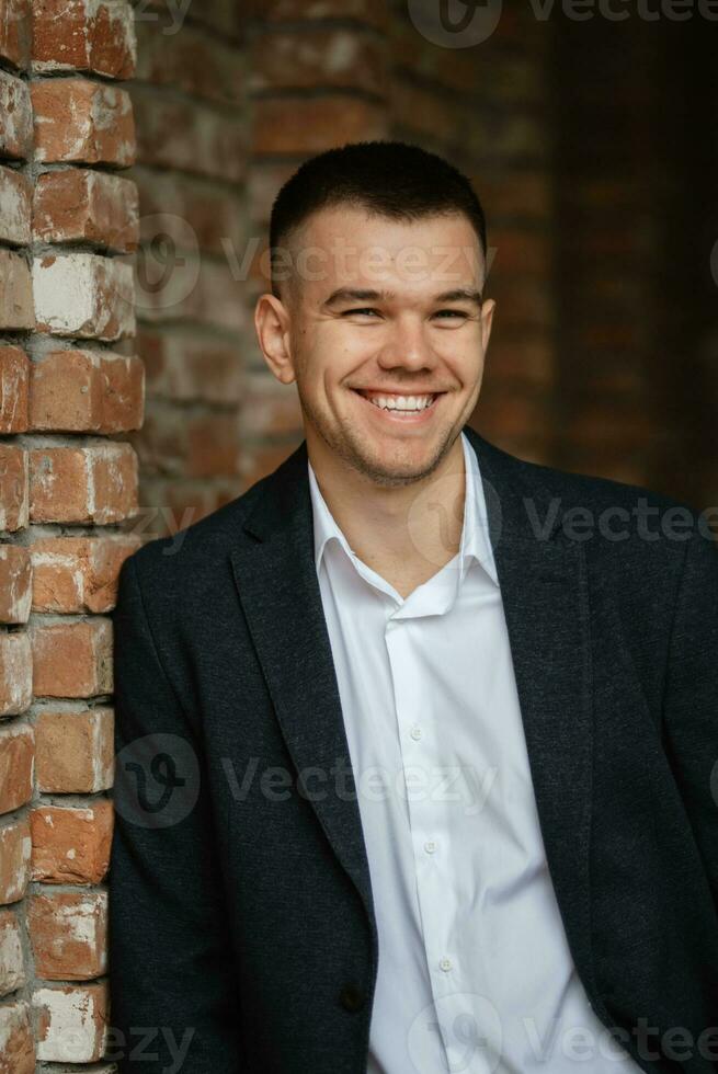 portret van een jong vent bruidegom in een donker wol pak foto