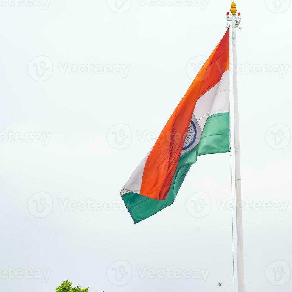 indiase vlag hoog op connaught plaats met trots in blauwe lucht, indiase vlag wapperen, indiase vlag op onafhankelijkheidsdag en republiek dag van india, tilt-up shot, wuivende indische vlag, har ghar tiranga foto