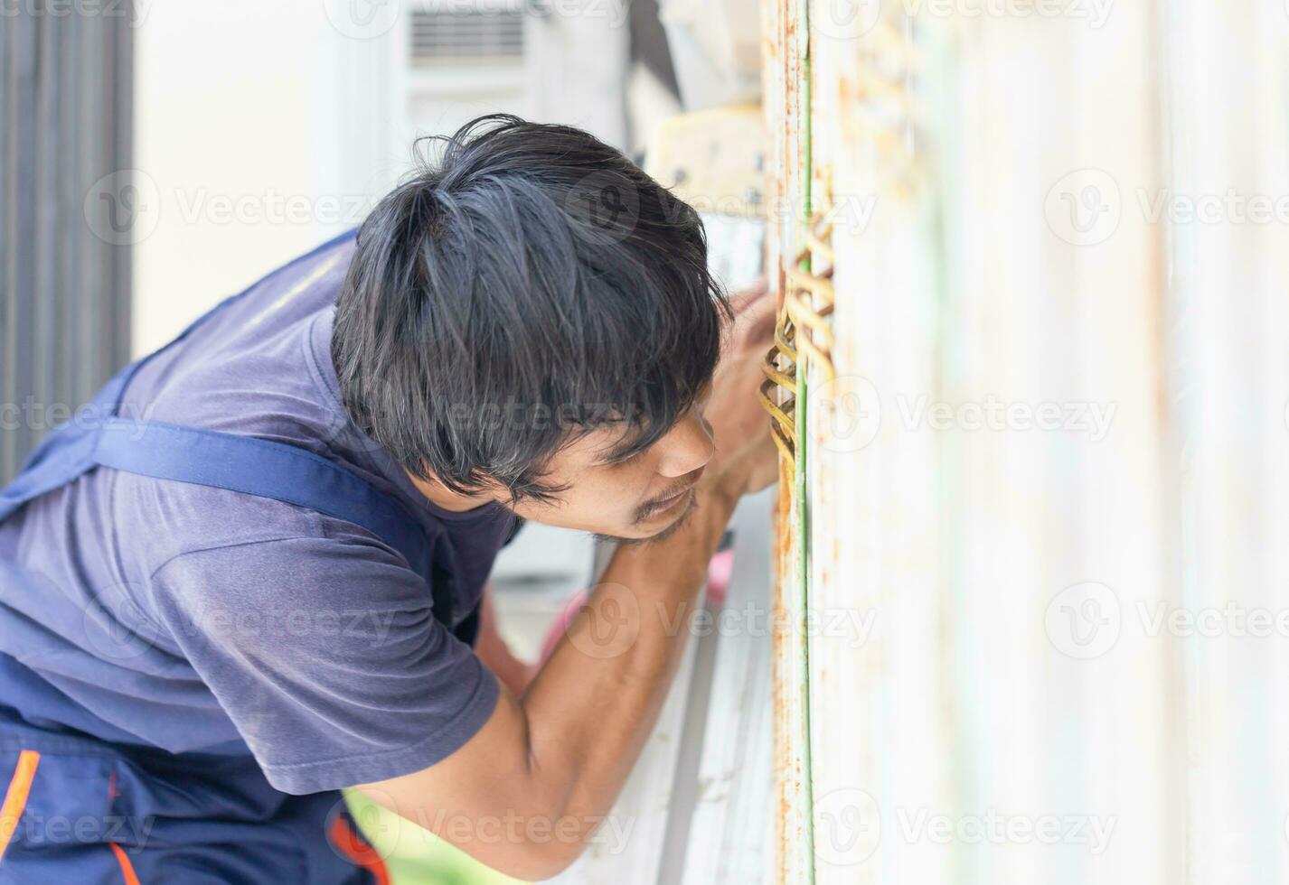 jong klusjesman vaststelling lucht conditioner eenheid, technicus Mens installeren een lucht conditioning in een cliënt huis, onderhoud en repareren concepten foto