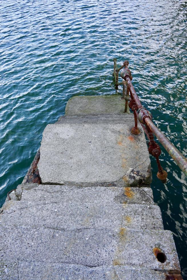 oude verlaten trappen in de zeehaven foto