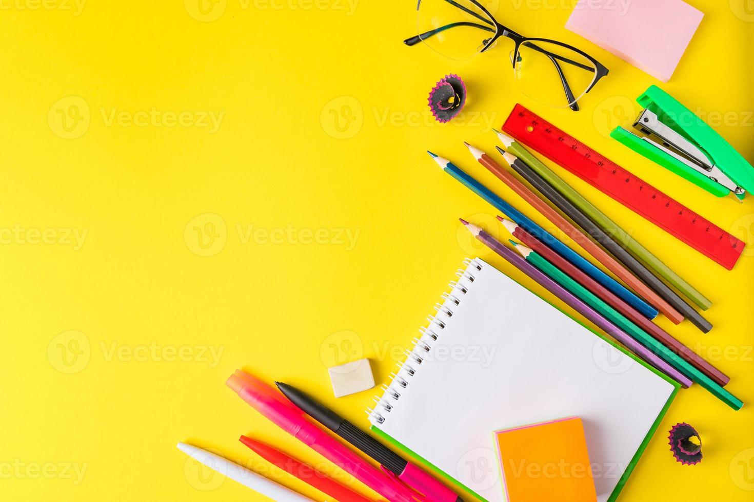 plat leggen van briefpapier op gele achtergrond terug naar school-concept foto