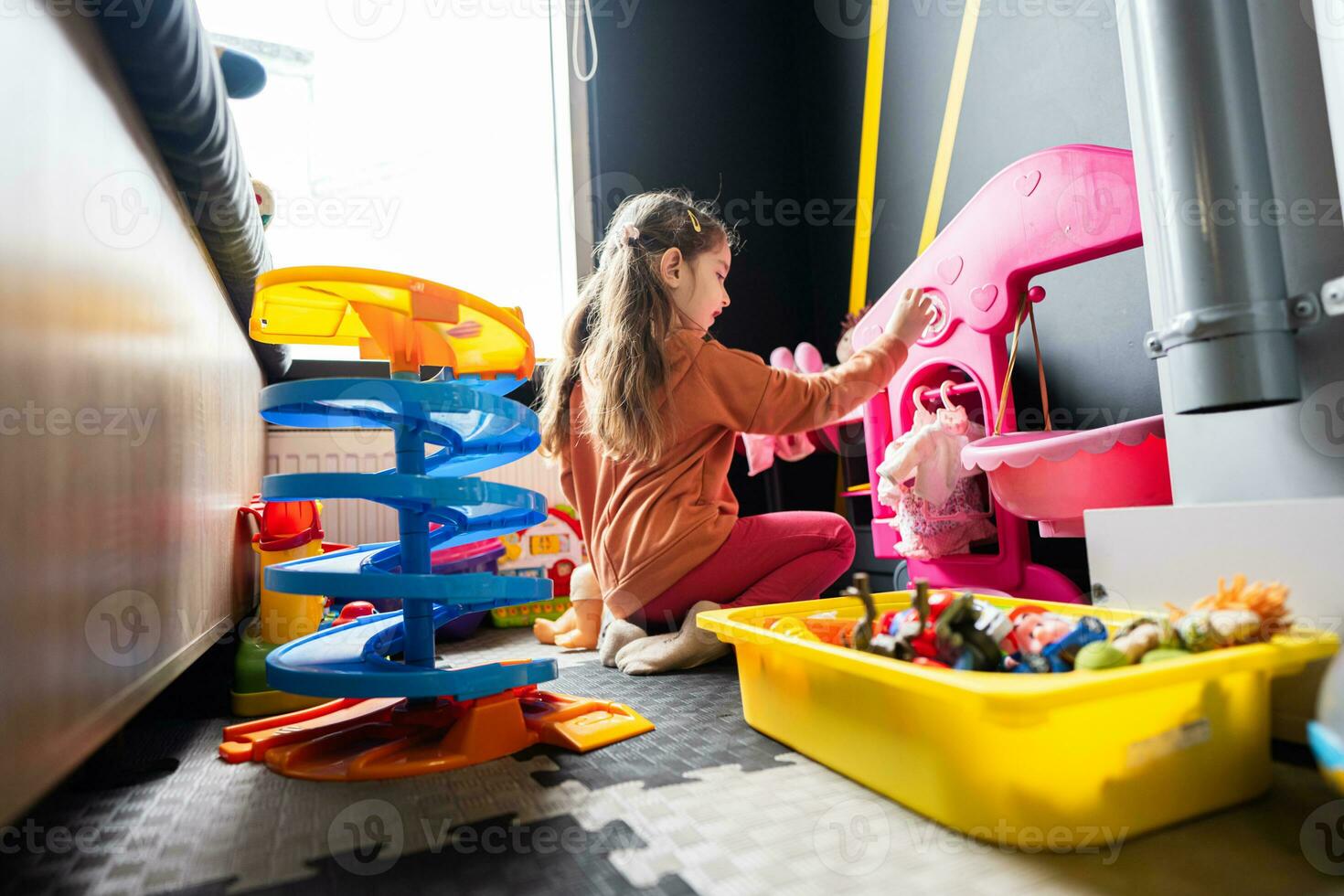 kleuter meisje kind in dag zorg centrum spelen met poppen speelgoed. foto