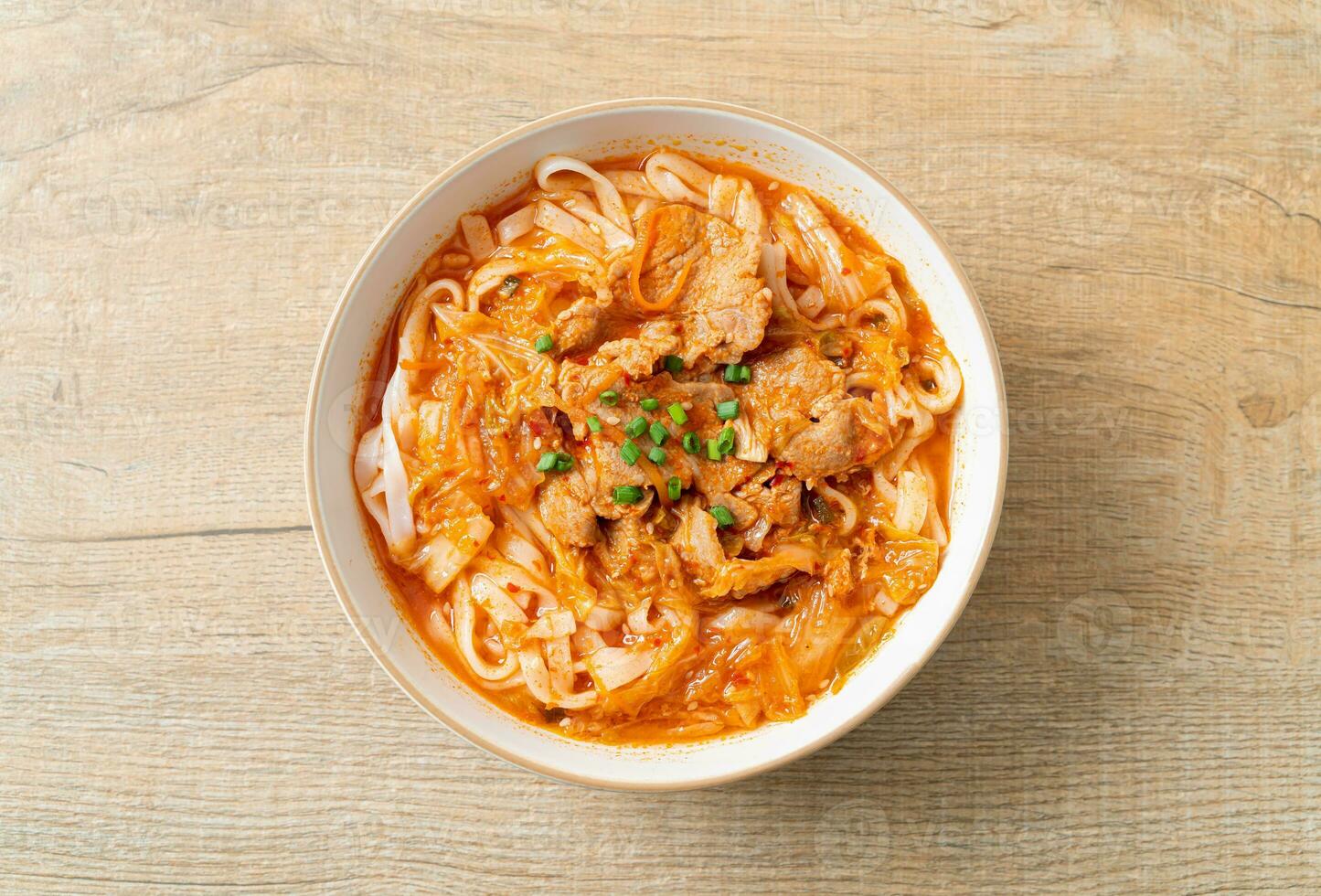 Koreaanse udon ramen-noedels met varkensvlees in kimchi-soep foto