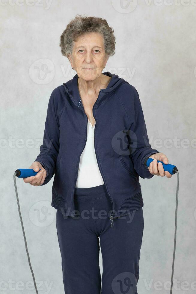 senior vrouw is gekleed in een sport kostuum foto