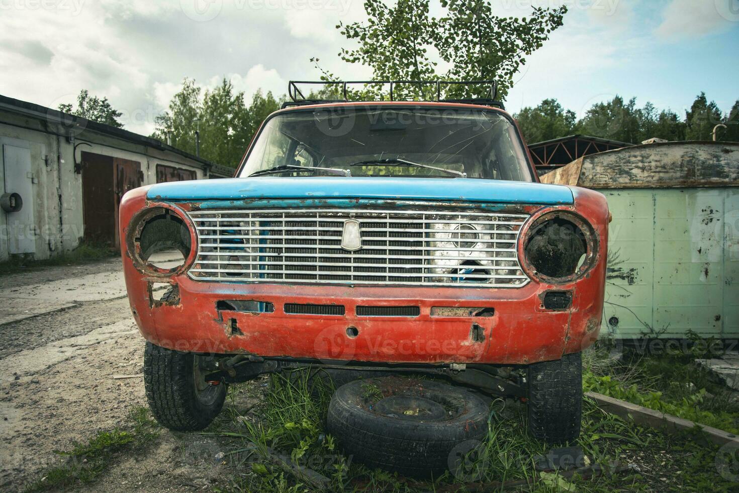 een oud gebroken klassiek auto verlaten Aan de straat. roestvrij oud machine foto