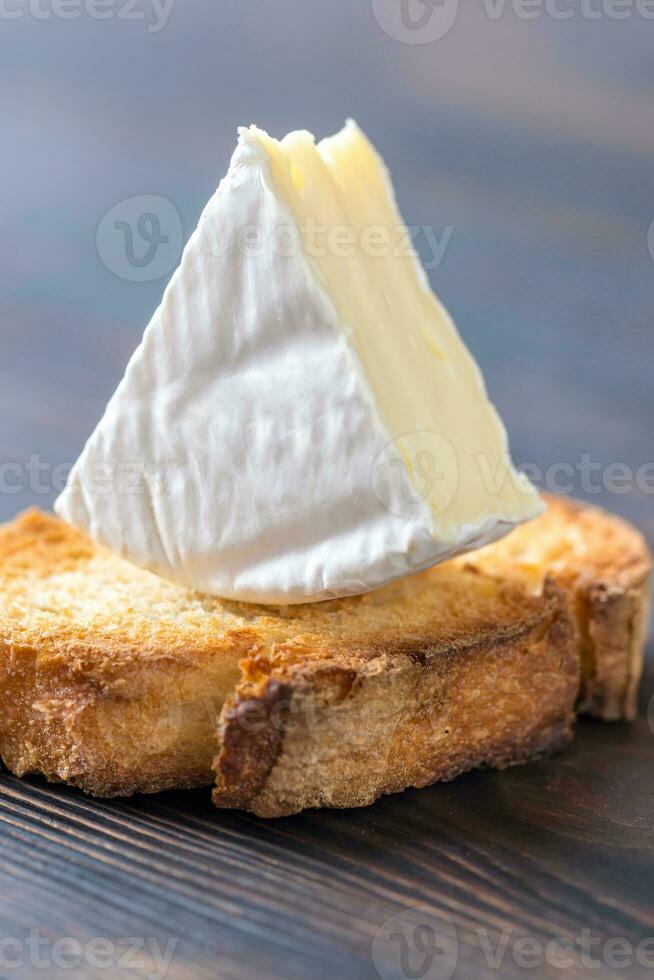 geroosterd brood met Camembert kaas Aan de houten bord foto
