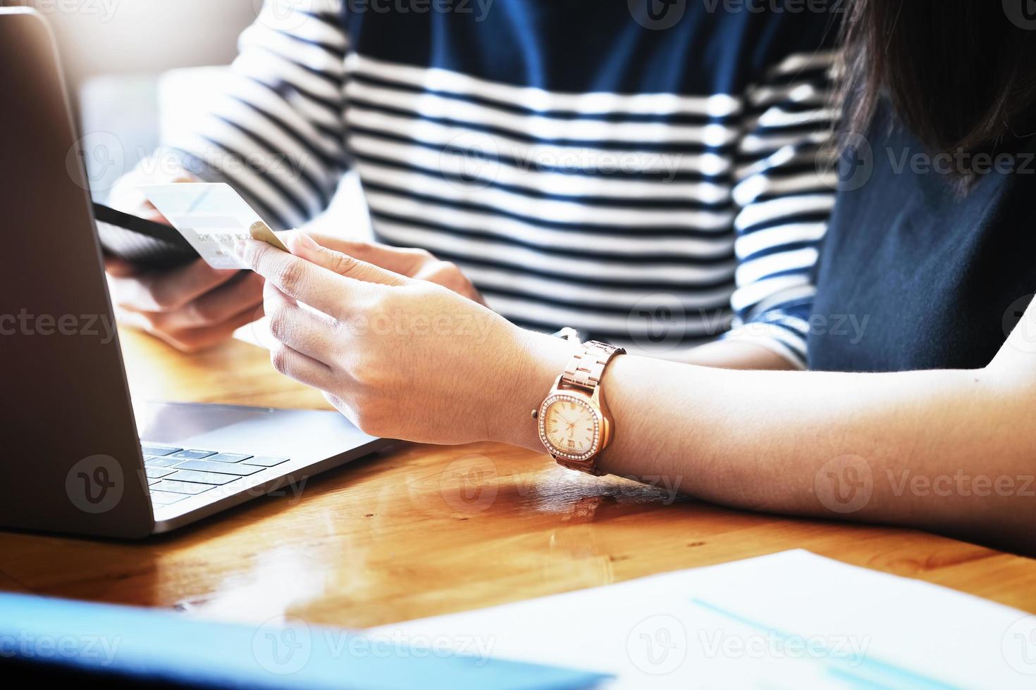 twee mensen die smartphone en computer gebruiken om online te winkelen foto