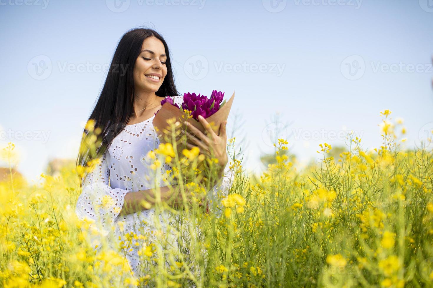 jonge vrouw in het koolzaadveld foto