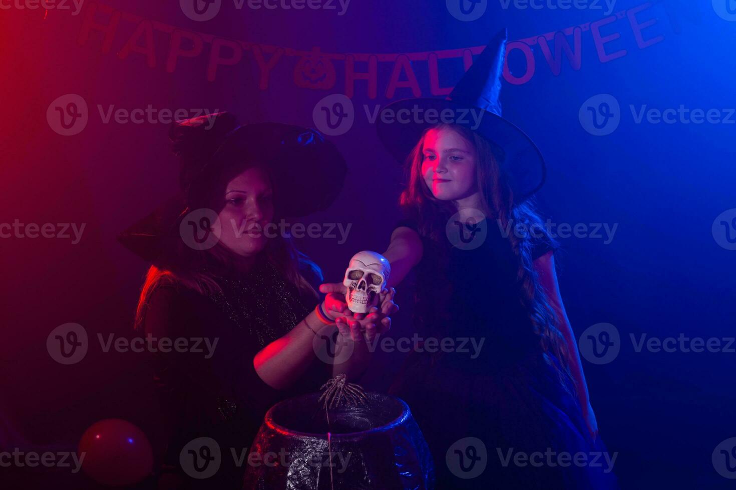 twee halloween heksen maken een toverdrank en toveren in halloween nacht. magie, vakantie en mysticus concept. foto