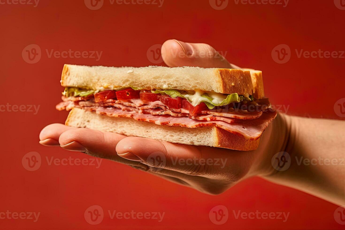 hand- Holding smakelijk belegd broodje Aan een rood achtergrond. ai gegenereerd foto