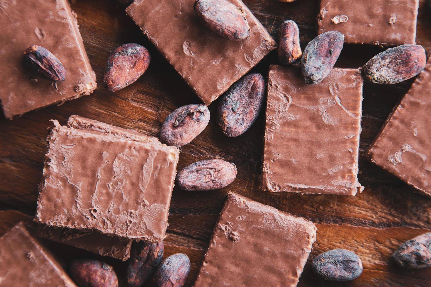 chocolade en cacaobonen met cacao op een zwarte achtergrond foto