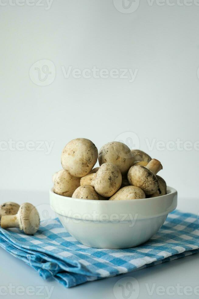 vers champignons paddestoel in een wit kom Aan tafel foto