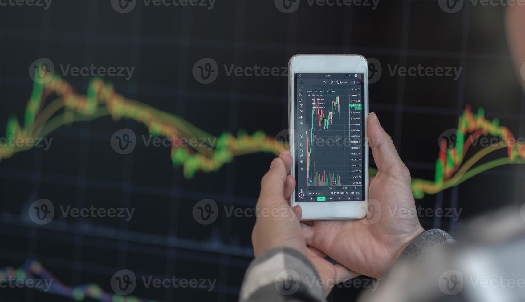 zakenman handelaar investeerder analist met behulp van mobiele telefoon app analytics voor cryptocurrency financiële beurs analyse analyseer grafiek handelsgegevens index investeringsgroei grafiek op smartphone scherm. foto