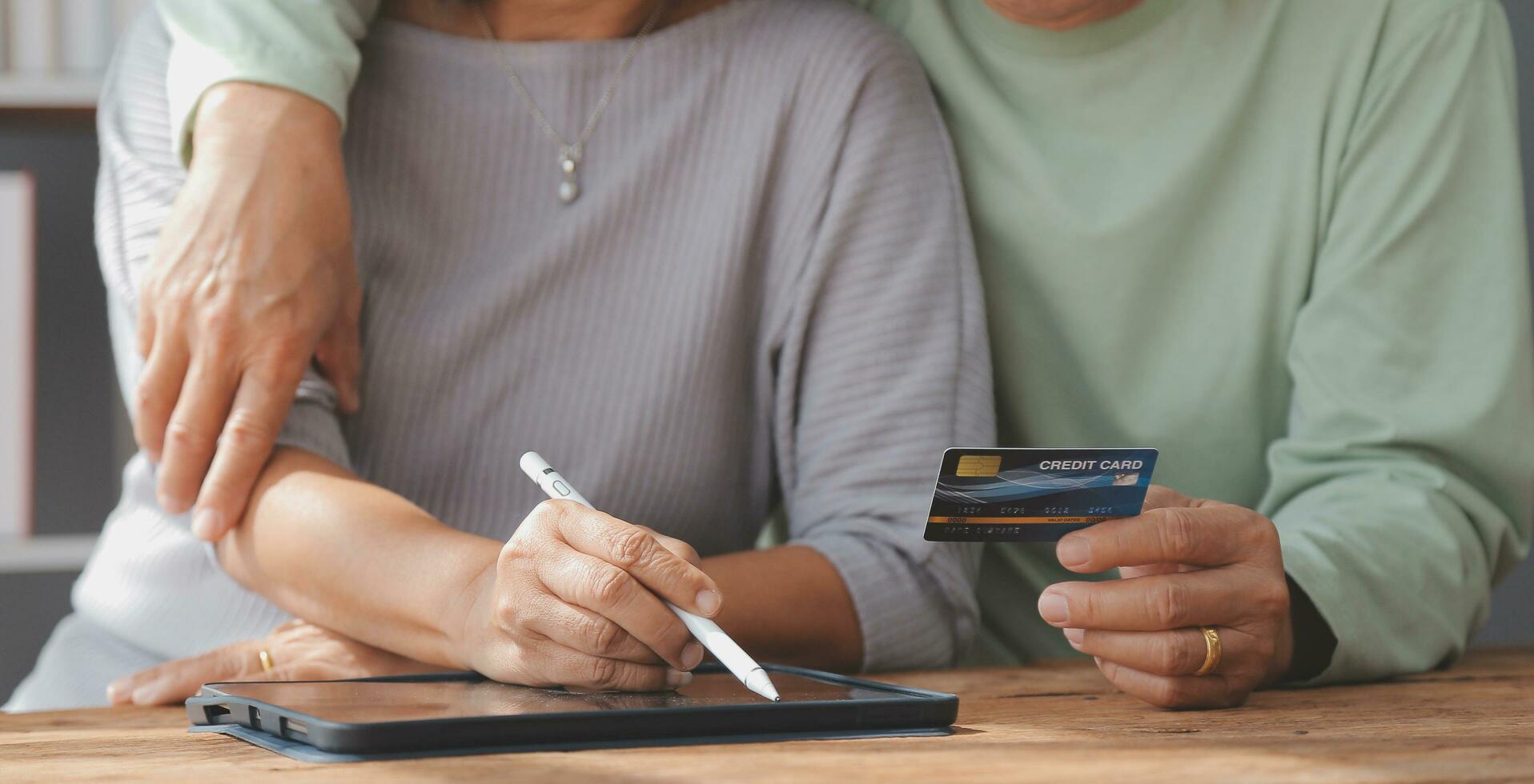 geschokt oud paar worden slachtoffers van online fraude gebruik makend van credit kaart telefoon naar betalen voor goederen bestellen onderhoud online Aan verdacht website. gefrustreerd ouder echtgenoten te hoge uitgaven geld Bij internet boodschappen doen foto