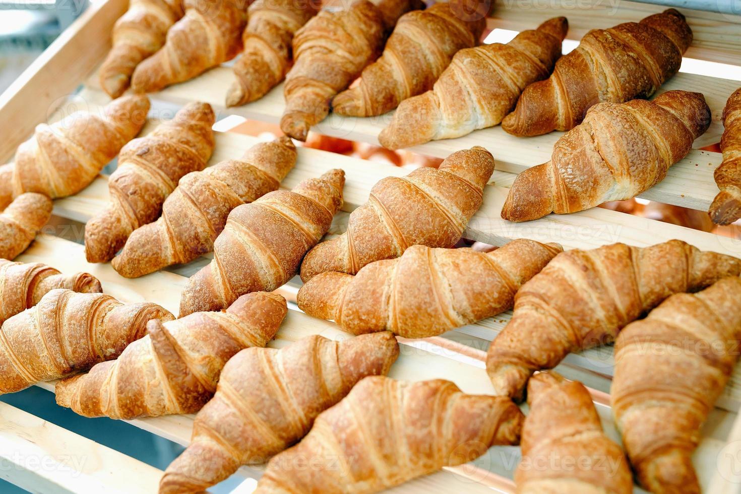 verse croissants met room op een houten plank. foto