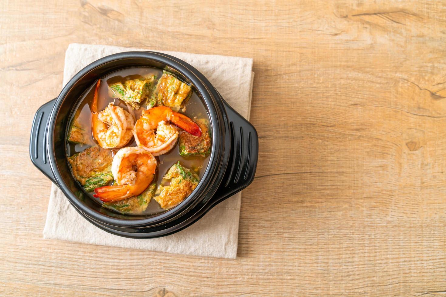 zure soep van tamarindepasta met garnalen en groenteomelet foto