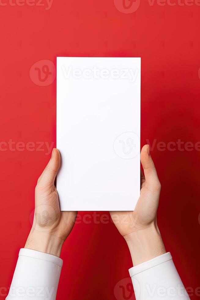 een menselijk hand- Holding een blanco vel van wit papier of kaart geïsoleerd Aan rood achtergrond. ai gegenereerd foto