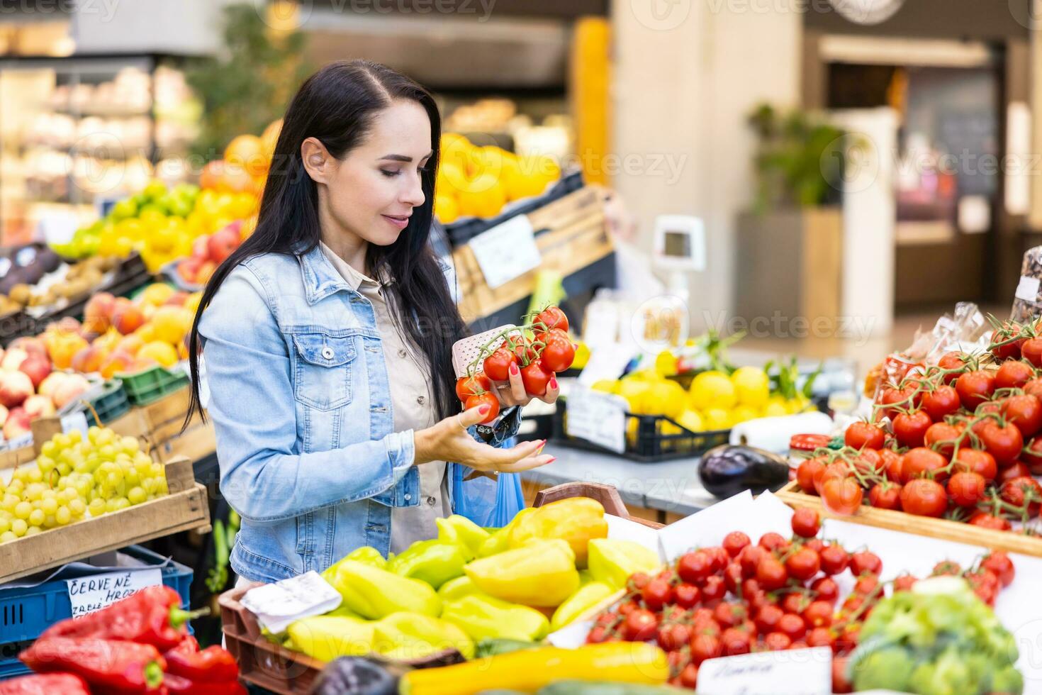 glimlachen mooi brunette cheques Aan kwaliteit van biologisch rood tomaten in de markt foto