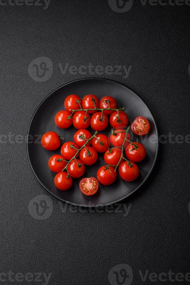 heerlijk vers kers tomaten Aan de takken net zo een ingrediënt voor Koken een vegetarisch schotel foto