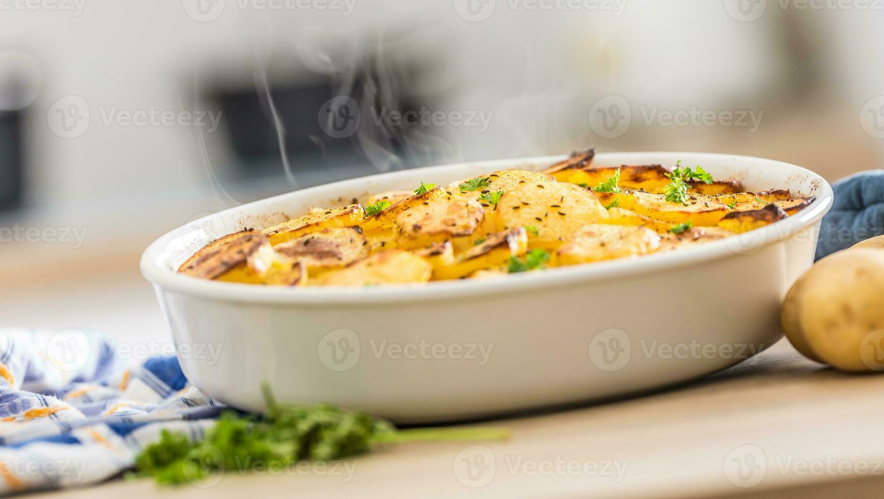 geroosterd aardappelen met specerijen en kruiden Aan keuken tafel foto