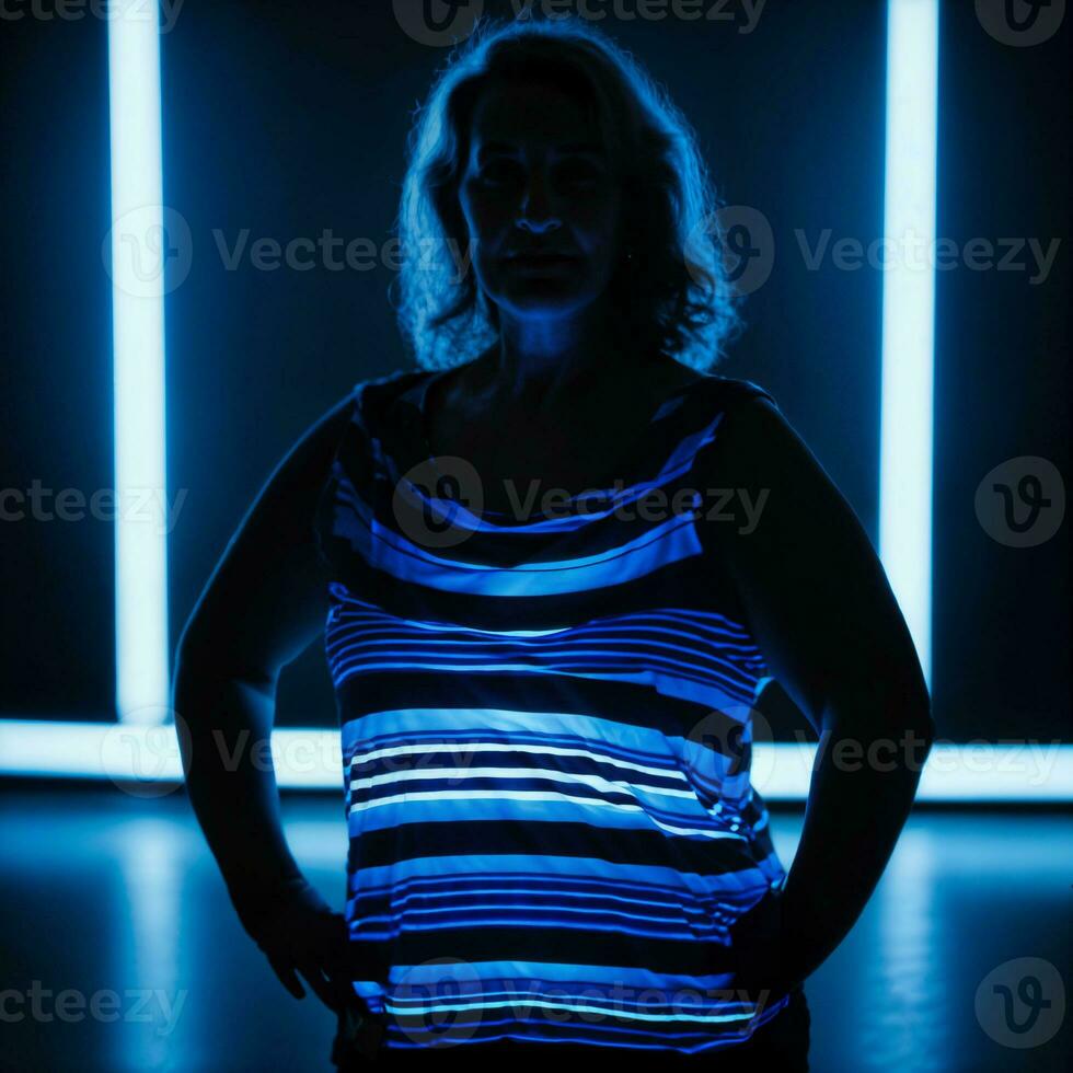 foto van midden- oud oud vrouw met blauw licht Aan zwart achtergrond, generatief ai