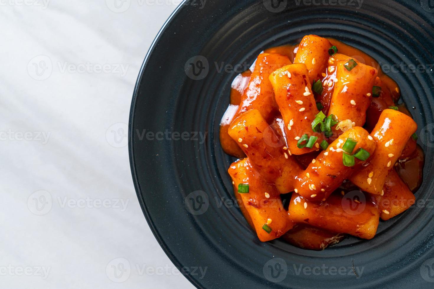 Koreaanse rijstwafelstok in pikante saus - tteokbokki foto