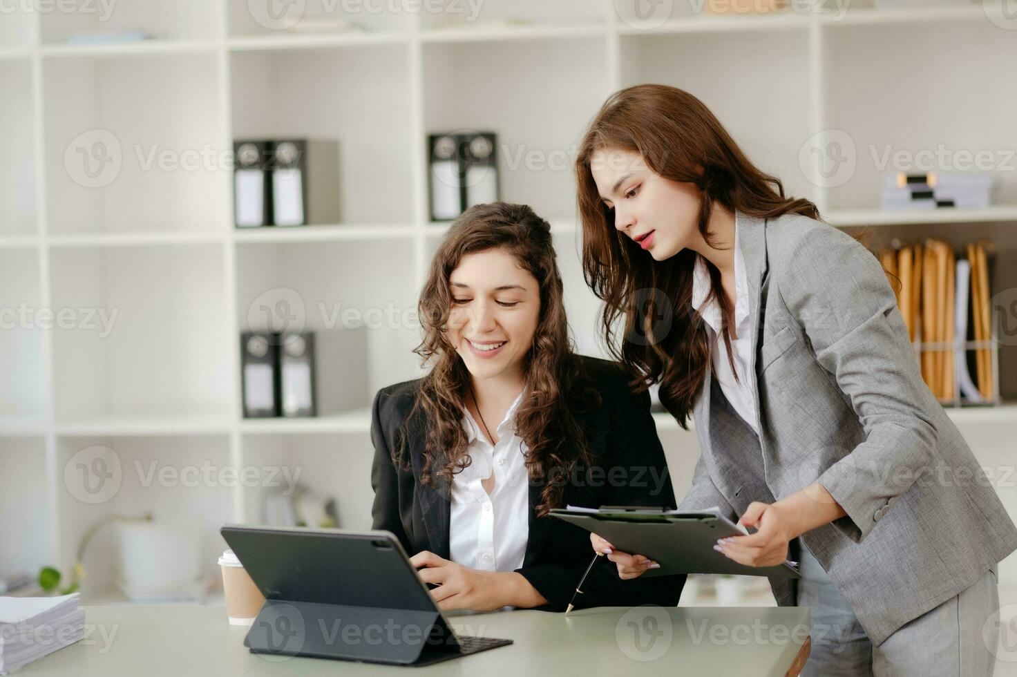 zakenvrouw leidend team vergadering en gebruik makend van tablet en laptop computer met financieel in coworking kantoor foto